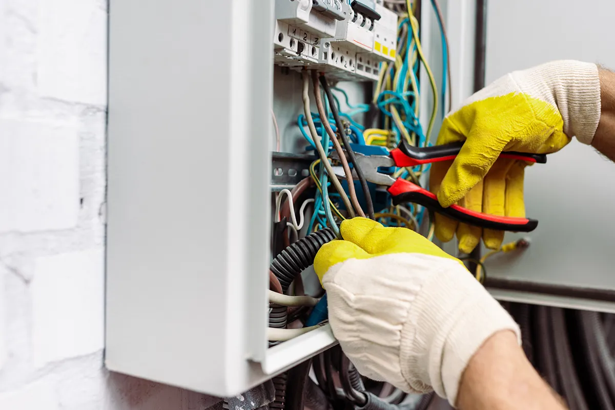 Electrician working on a breaker board